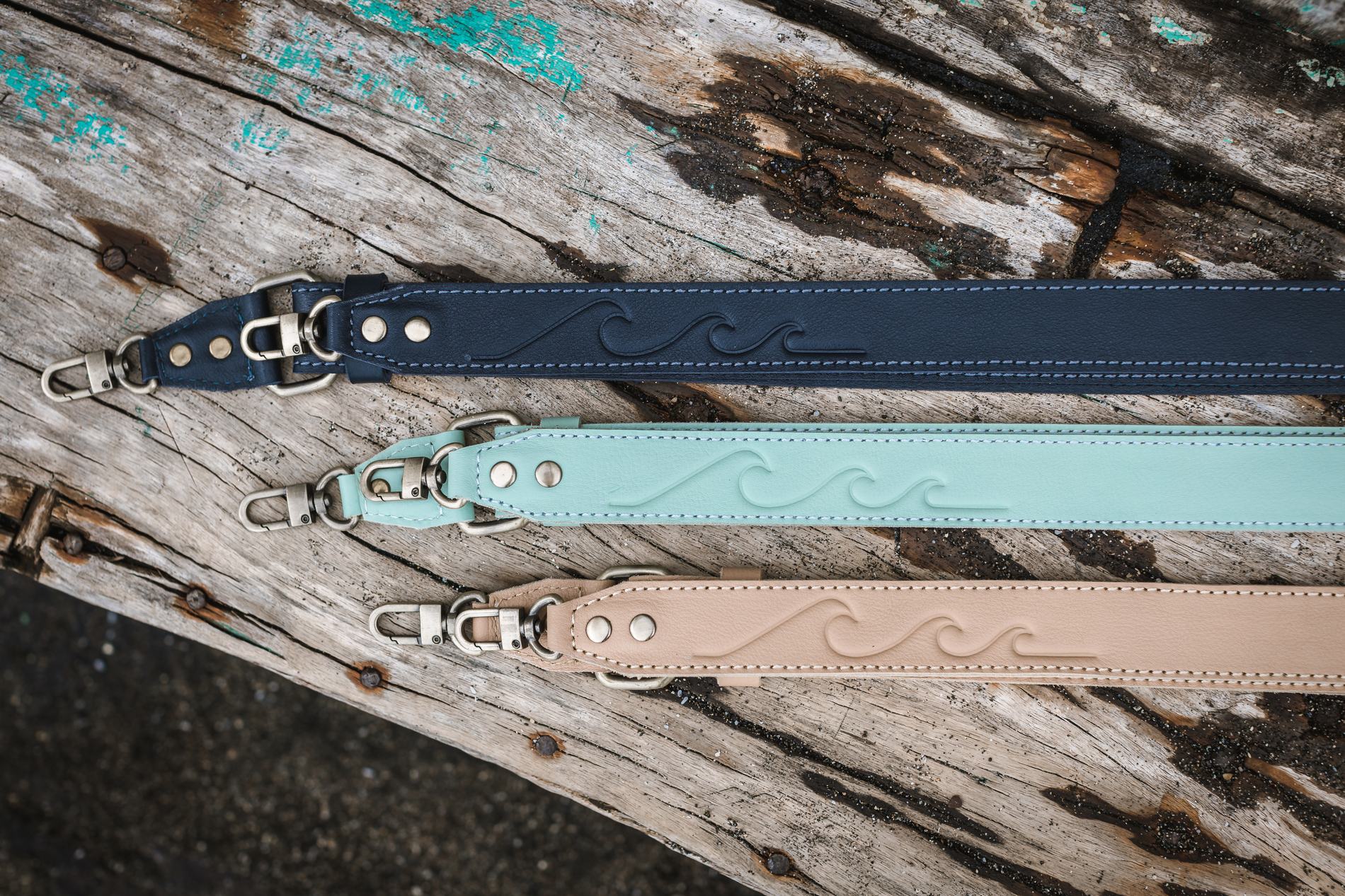 Three straps with pressed wave patterns laid on weathered timber