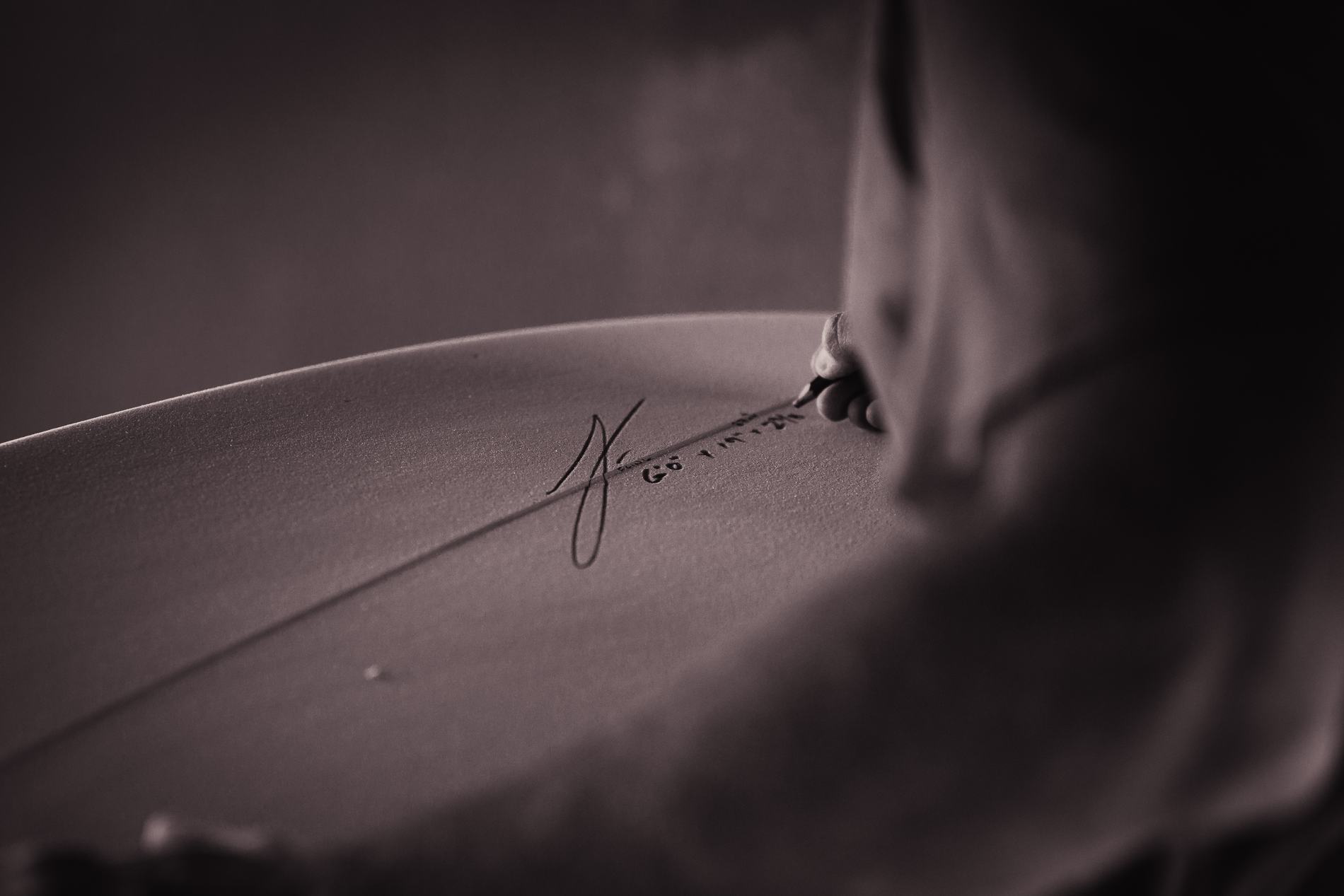 A signature in pencil on a board's blank
