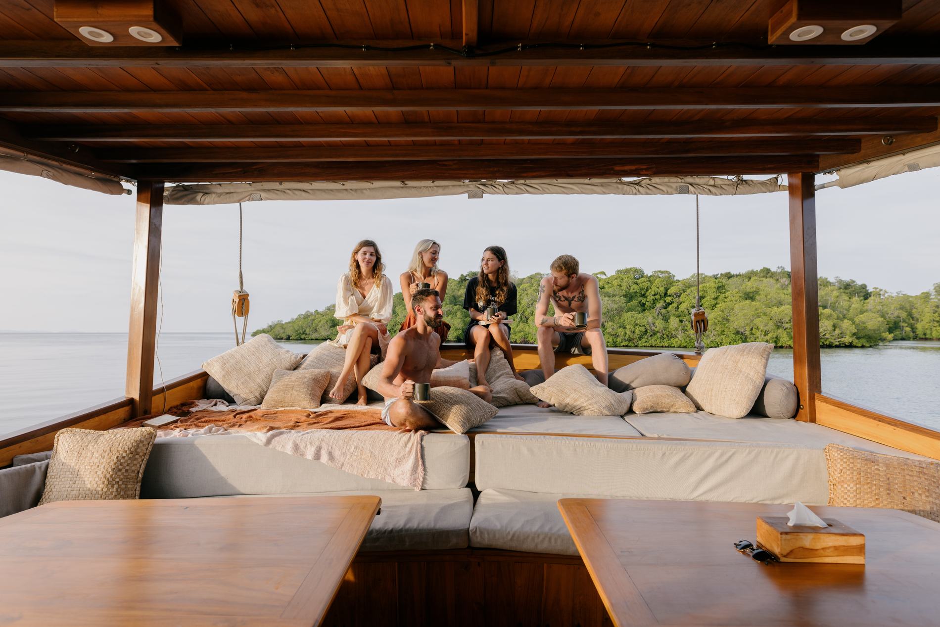Guests sitting together on the shaded deck daybed