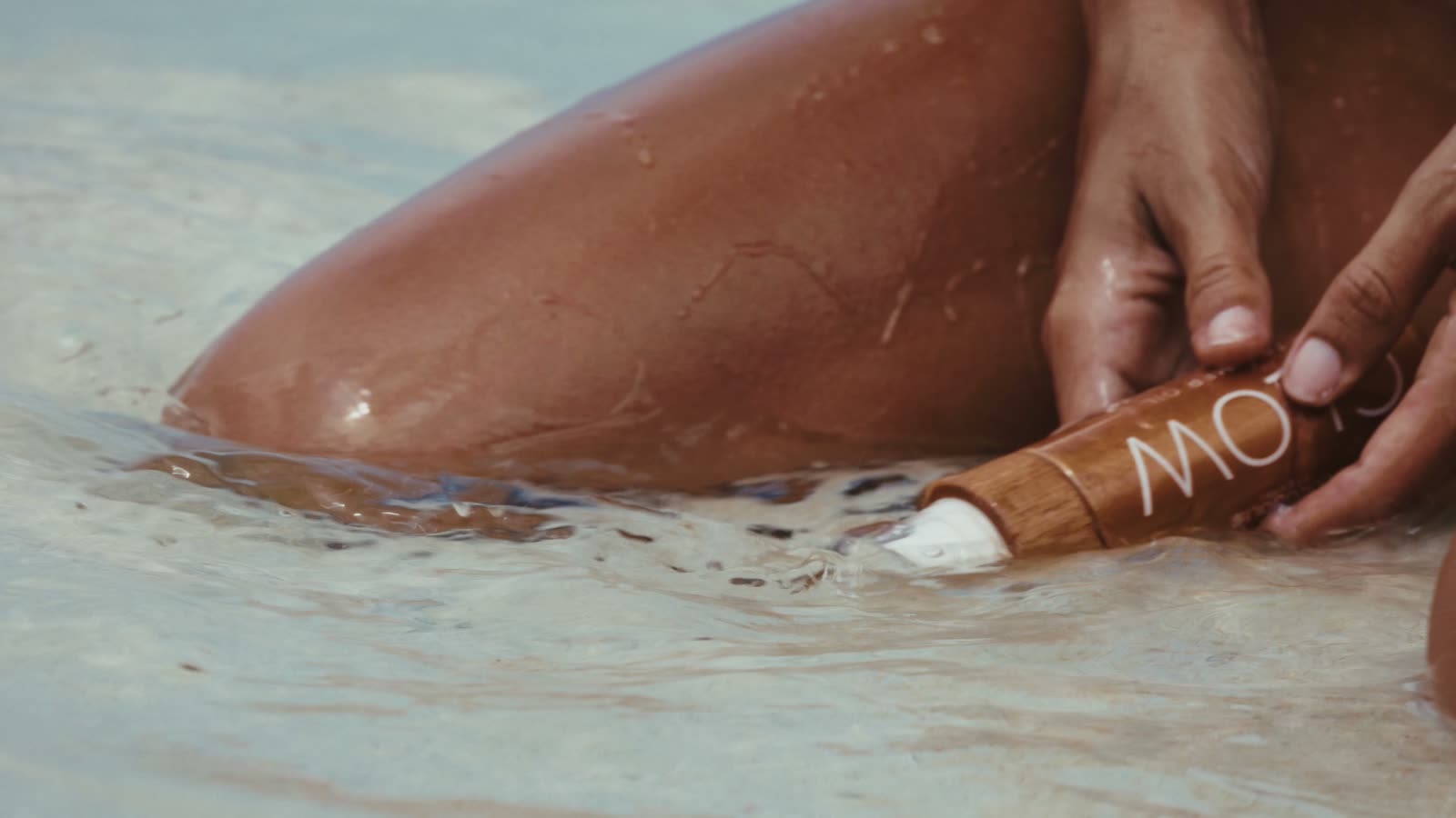 Cocosolis on a beach with a sailing ship offshore
